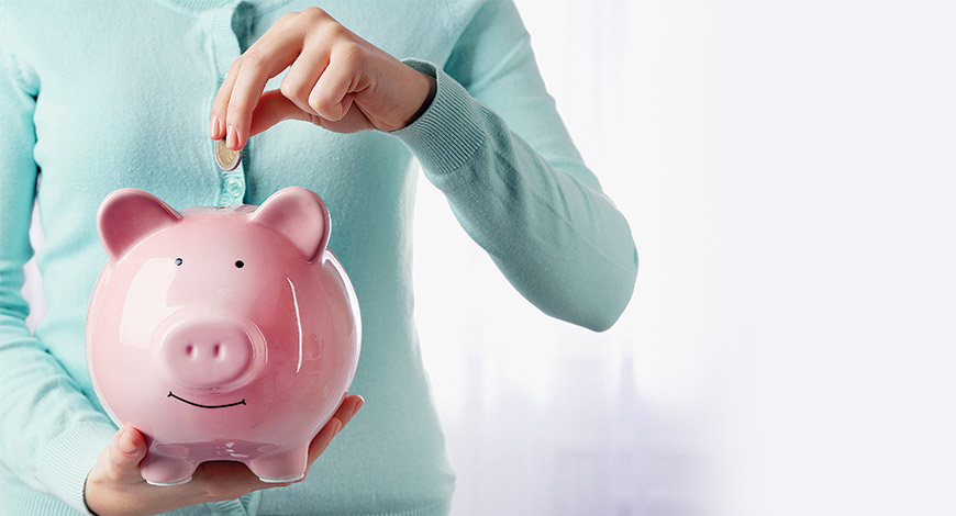 Image of a woman holding a pink pig money box